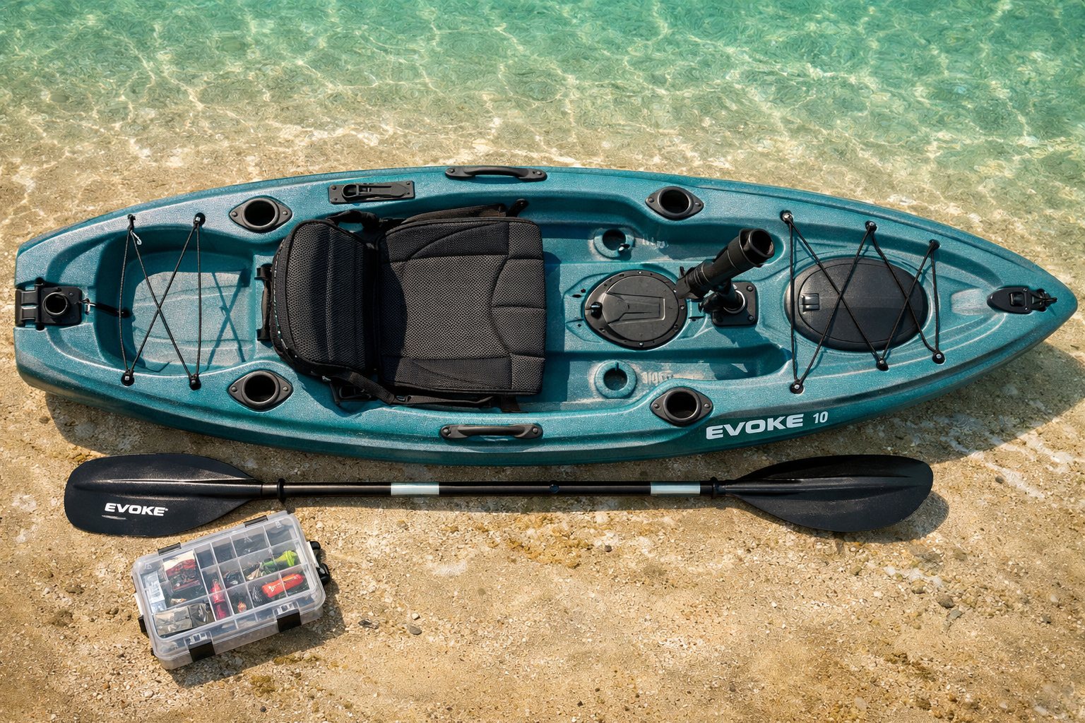 Close-up overhead flat-lay of the Evoke 10 sit-on-top kayak on a sandy saltwater flat, showing the deck layout with 2